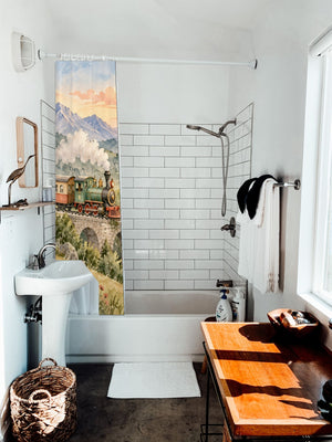 Sunrise Train shower curtain hanging on the rod over a white bathtub