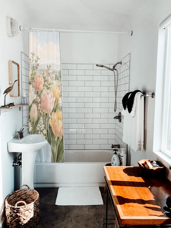 Pastel Tulip Field shower curtain hanging on the rod over a white bathtub