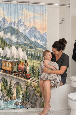 Mom holding her baby on the tub edge next to the Panoramic Train Journey shower curtain