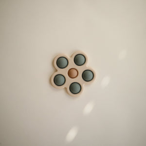 Colorful flower press toy for babies, angled view showcasing its vibrant design and engaging features.