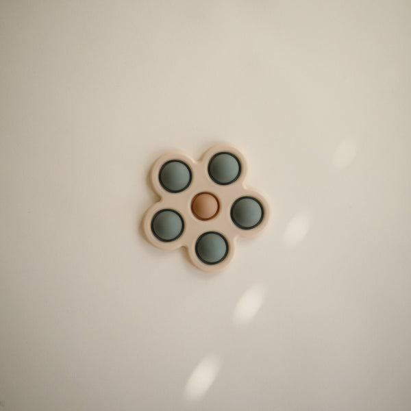 Colorful flower press toy for babies, angled view showcasing its vibrant design and engaging features.