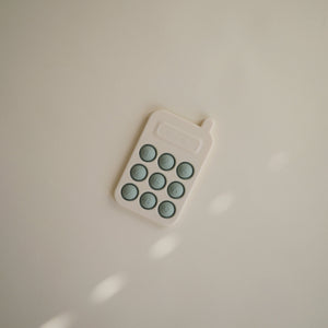 Colorful phone press toy for babies, designed to stimulate sensory play and fine motor skills.