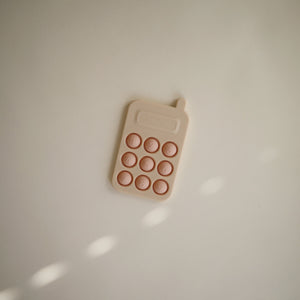 Colorful phone press toy for babies, promoting sensory play and fine motor skills development. Angle 6 view.