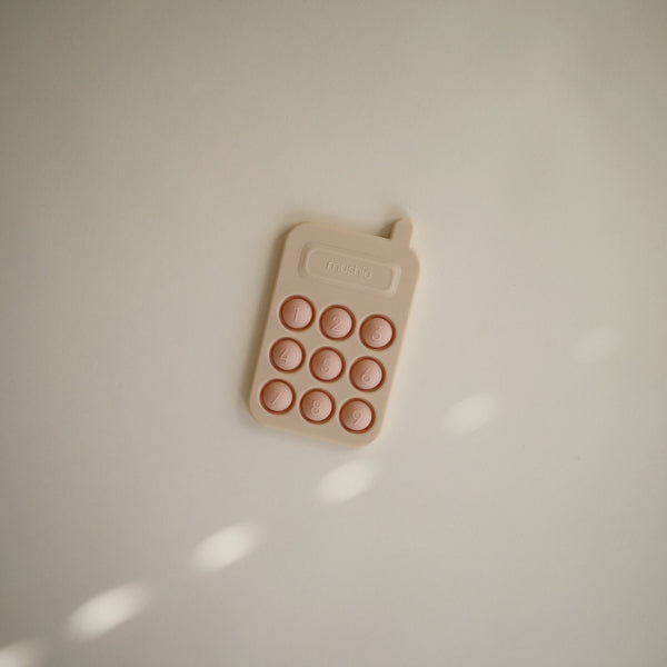 Colorful phone press toy for babies, promoting sensory play and fine motor skills development. Angle 6 view.