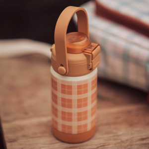 Sip + Chug 2 in 1 Thermo Water Bottle 12 oz in Buckwheat Plaid, angled view showcasing its stylish design and functionality.