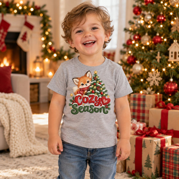 Child wearing the Cozy Season toddler t-shirt at Christmas