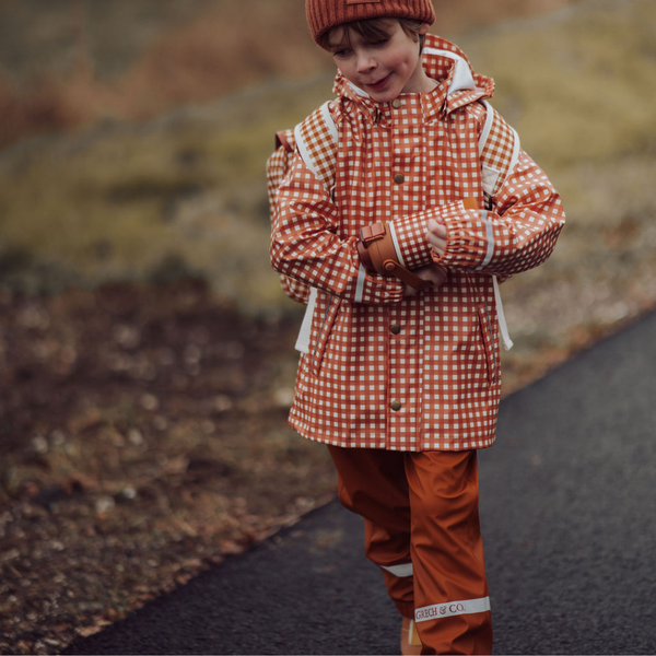 Sienna rain pants for babies, angle view showcasing waterproof fabric and adjustable features. Perfect for outdoor play.