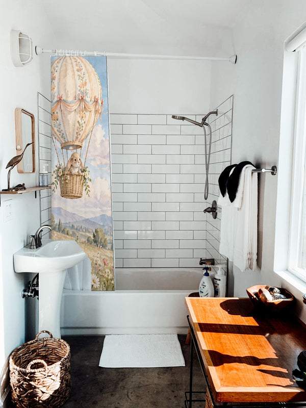 Meadow Hot Air Balloons shower curtain hanging on the rod over a white bathtub