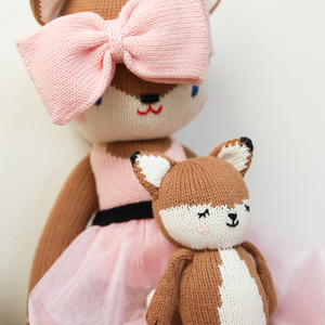 Knit baby fox doll in a cozy pose, perfect for cuddles and playtime.
