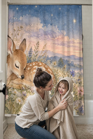 Mom drying her toddler in a hooded towel in front of the Resting Deer shower curtain