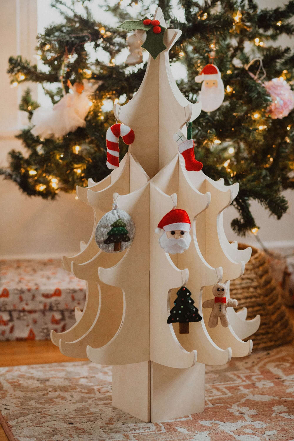 Montessori wooden Christmas tree with colorful felt ornaments for kids' holiday decor.
