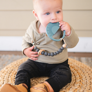 Sage Sunburst Teething Toy at angle 8, perfect for soothing baby's gums and promoting sensory development.