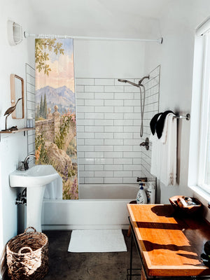 Castle Bridge Fairy Tale shower curtain hanging on the rod over a white bathtub