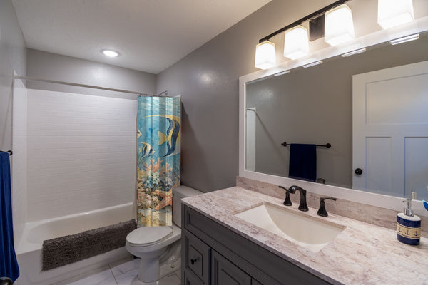Coral Reef Ocean shower curtain pulled open in a gray kids bathroom
