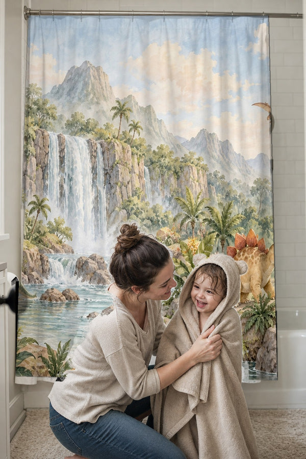 Mom drying her toddler in a hooded towel in front of the Tropical Dinosaur Garden shower curtain