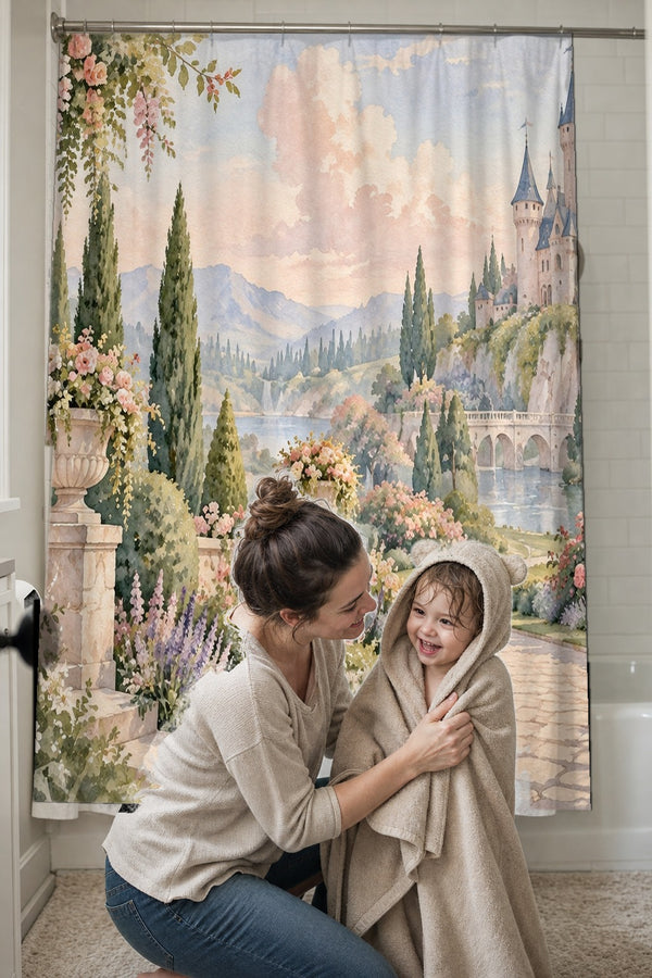 Mom drying her toddler in a hooded towel in front of the Castle Garden Fairy Tale shower curtain