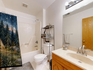 Starry Tent Camping shower curtain on a tub shower combo in an American family bathroom