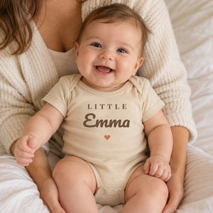 Baby wearing the Little Name baby bodysuit
