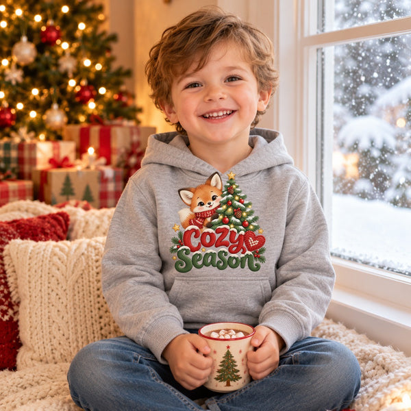Child wearing the Cozy Season toddler hoodie at Christmas