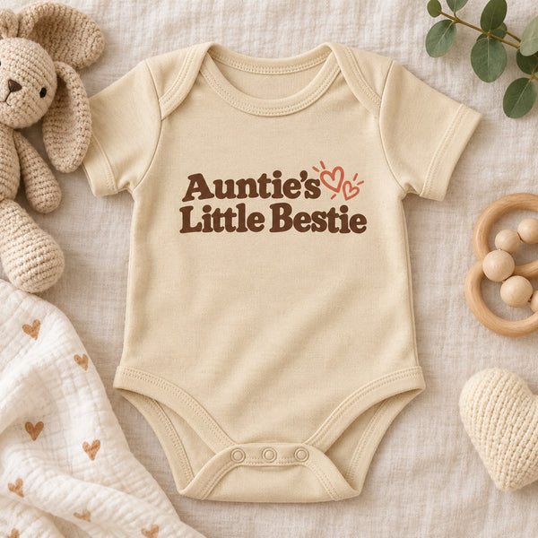 Styled flat lay of the Auntie's Little Bestie baby bodysuit
