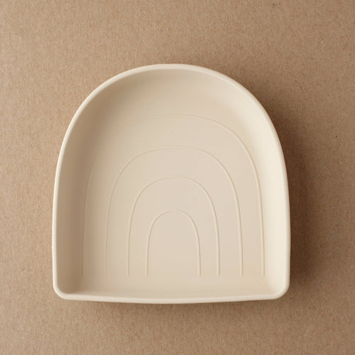 Rainbow silicone suction plate for babies, angled view showcasing vibrant colors and secure suction design.