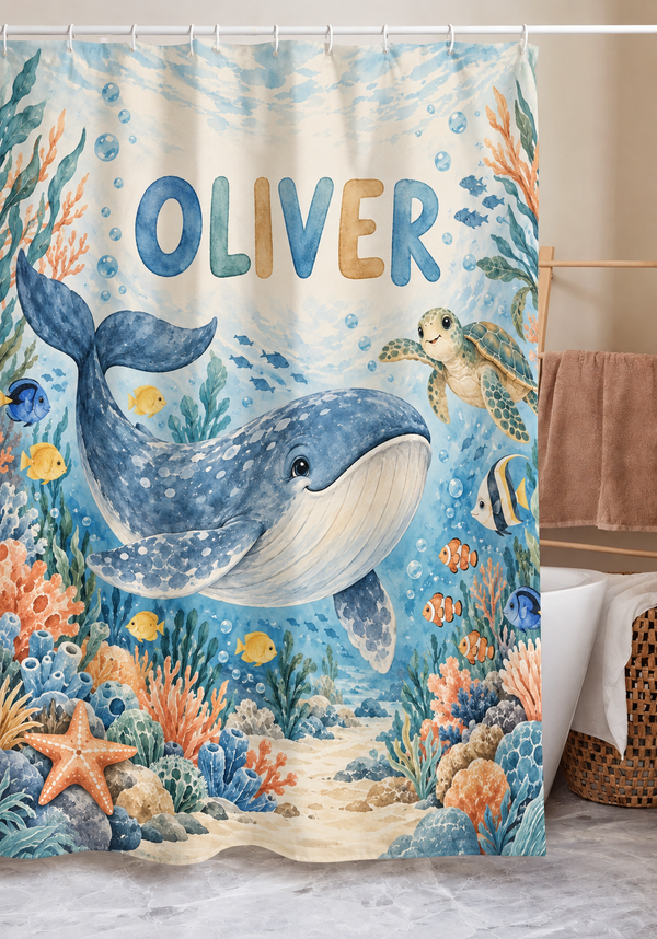 Personalized whale and sea turtle shower curtain with the name Oliver hanging in a kids bathroom