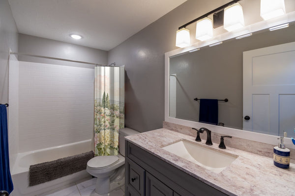 Hydrangea Garden shower curtain pulled open in a gray kids bathroom