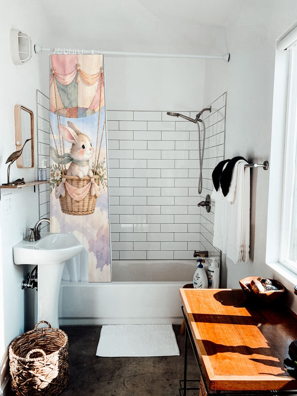 Bunny Hot Air Balloon shower curtain hanging on the rod over a white bathtub