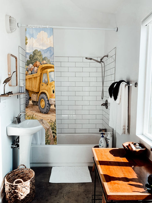 Dump Truck Road shower curtain hanging on the rod over a white bathtub