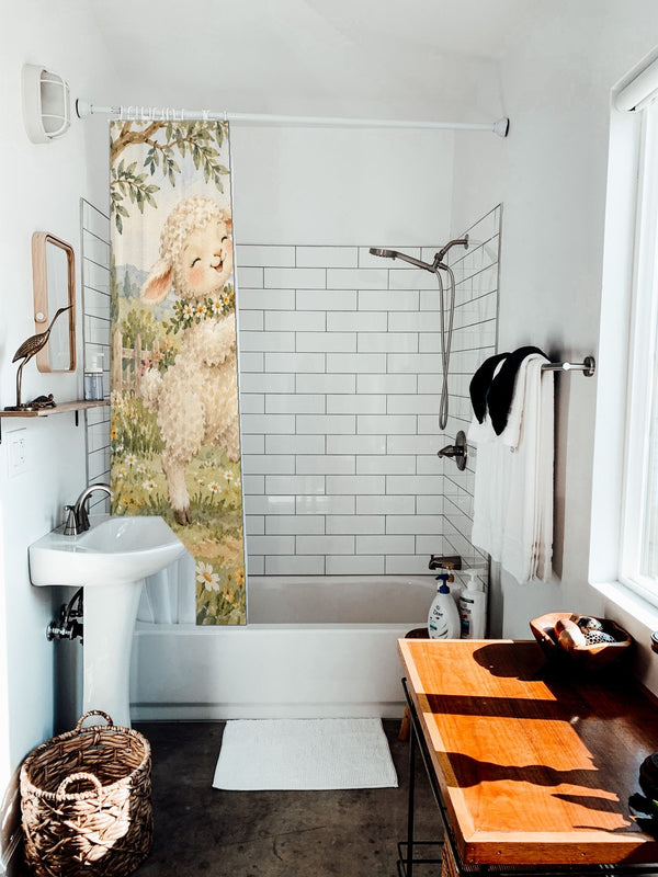 Lamb and Bunny Music shower curtain hanging on the rod over a white bathtub