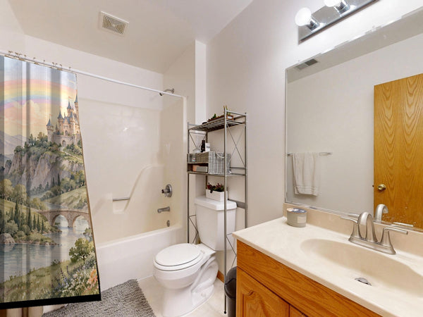 Rainbow Castle Fairy Tale shower curtain on a tub shower combo in an American family bathroom