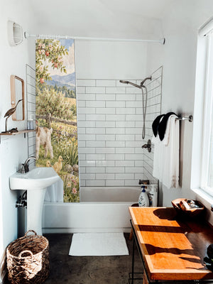 Peaceful Farm shower curtain hanging on the rod over a white bathtub