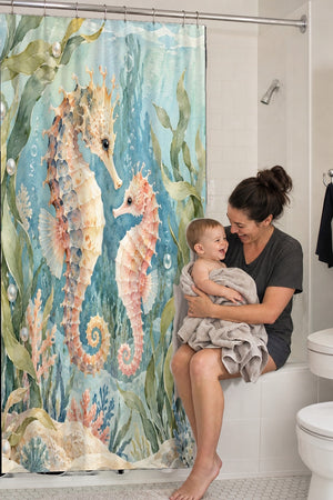 Mom holding her baby on the tub edge next to the Seahorse Pair Ocean shower curtain