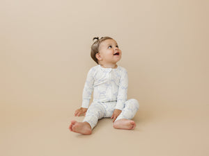 Blue Belle Ribbed Bamboo Zippy Pajamas for babies, featuring a cozy design and soft fabric, angle view.