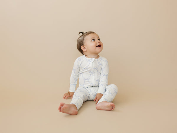 Blue Belle Ribbed Bamboo Zippy Pajamas for babies, featuring a cozy design and soft fabric, angle view.