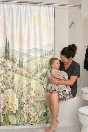 Mom holding her baby on the tub edge next to the Hydrangea Garden shower curtain