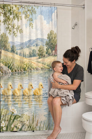 Mom holding her baby on the tub edge next to the Ducklings Pond Farm shower curtain