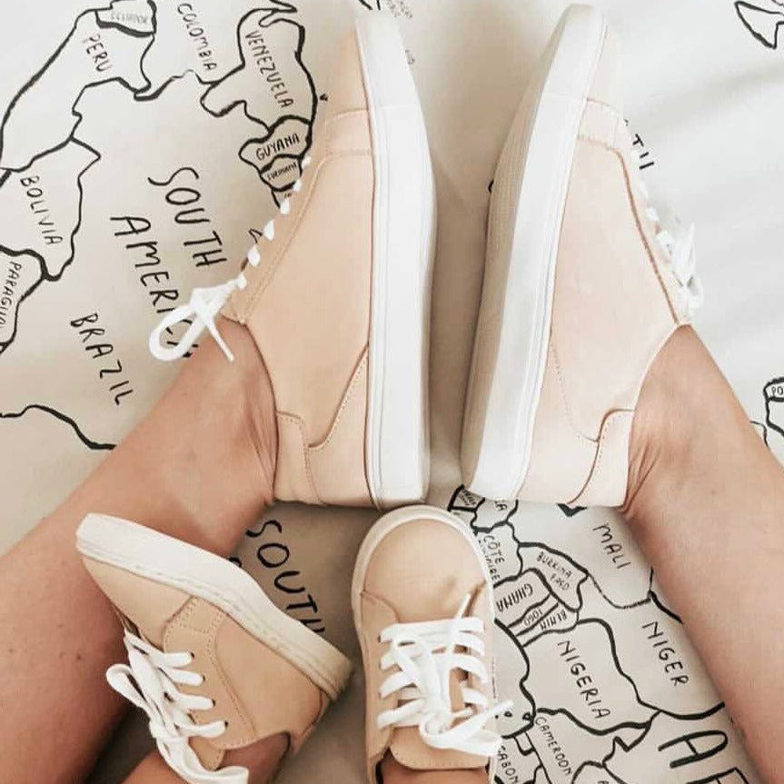 Tan nubuck low top sneakers for babies, stylish and comfortable footwear for little ones.