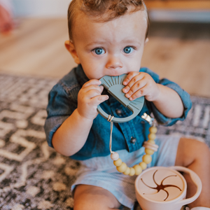 Sage Sunburst Teething Toy at angle 9, perfect for soothing baby's gums and promoting sensory play.