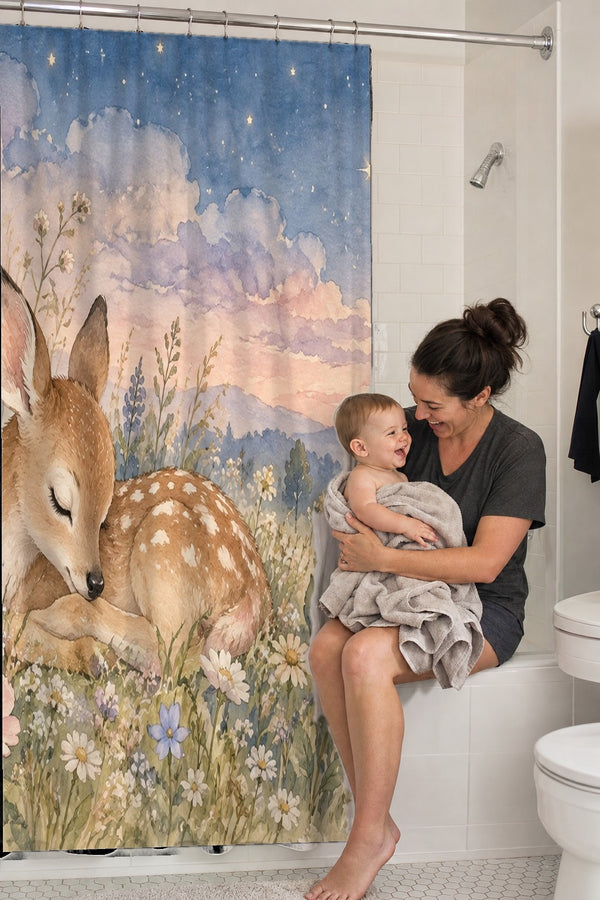 Mom holding her baby on the tub edge next to the Resting Deer shower curtain