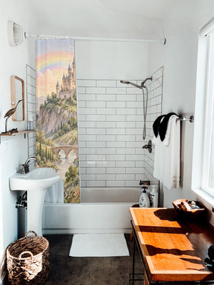 Rainbow Castle Fairy Tale shower curtain hanging on the rod over a white bathtub