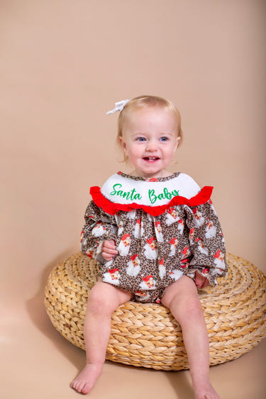 Santa baby smocked ruffle romper for infants, perfect for festive occasions and holiday celebrations.