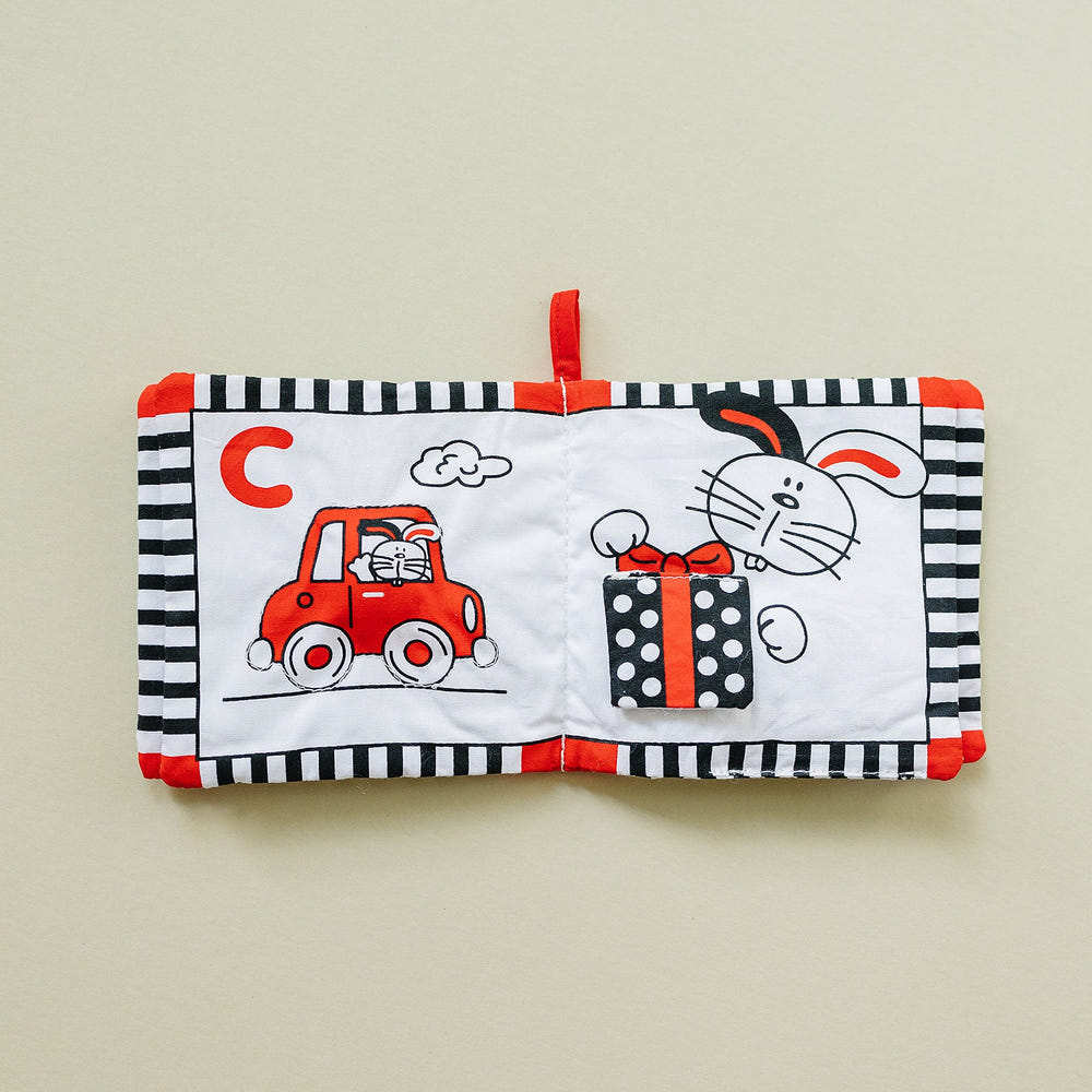 Soft cloth ABC book in high contrast black, white, and red for babies, promoting early learning and visual stimulation.