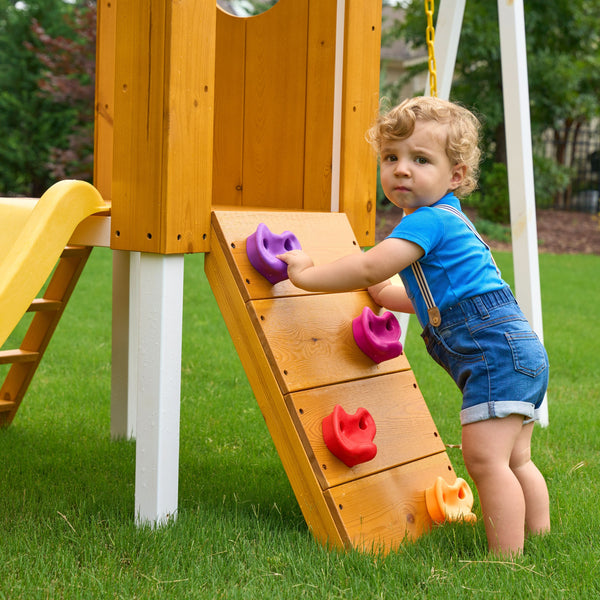 Compact wooden toddler swing set for outdoor play, perfect for babies and kids in a forest setting.