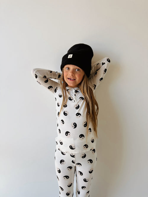 Bamboo two-piece black and white yin yang pajamas for babies, angle view showcasing soft fabric and stylish design.