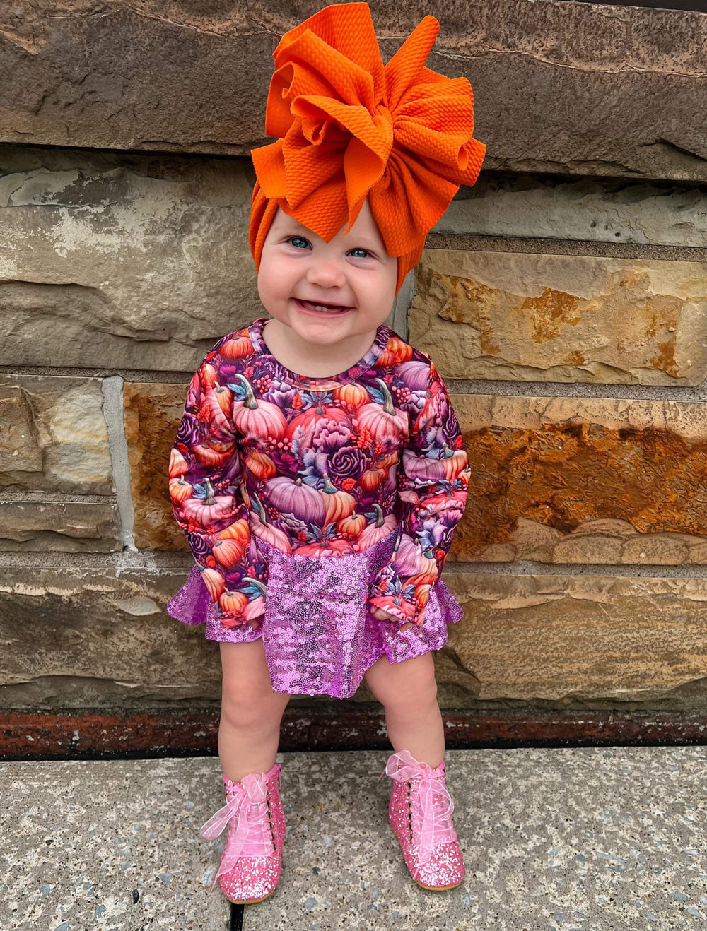 Purple pumpkin long sleeve mesh skirted romper for babies, stylish and comfortable clothing for little ones.