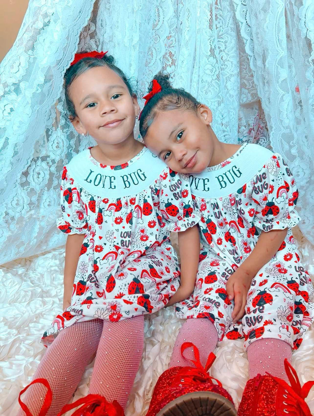 Smocked love bug dress for babies, featuring a charming design and comfortable fit. Perfect for any occasion.