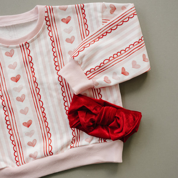 Laced with Love Crewneck Sweatshirt for babies, stylish and cozy, shown at a 15-degree angle.