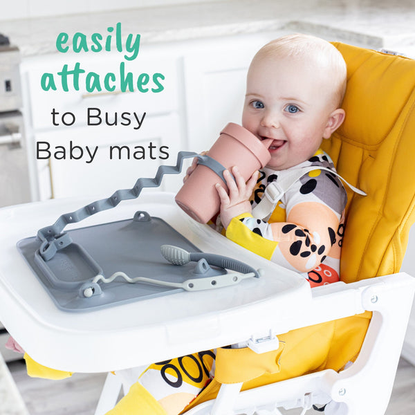 "Bottle Bungee for secure baby bottle holding, angled view showcasing its design and functionality."