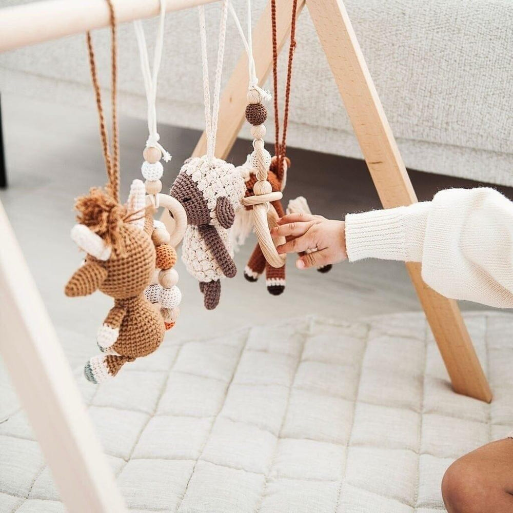 Handmade crochet toys for baby gym in farmhouse style, perfect for playtime and development.
